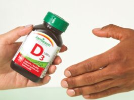Jamieson Shareholders Approve Kirin Takeover, With 29.5% Opposed Jamieson Wellness Kirin shareholder vote: a Jamieson vitamin D3 bottle handed from one person to another, illustrating the sale of the company to Kirin Holdings