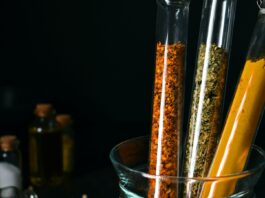 Blood-Sugar Botanicals Have a Dose Problem Turmeric, cinnamon and dried herbs in laboratory test tubes — natural products for blood sugar under the evidence lens