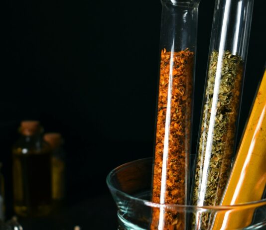 Blood-Sugar Botanicals Have a Dose Problem Turmeric, cinnamon and dried herbs in laboratory test tubes — natural products for blood sugar under the evidence lens